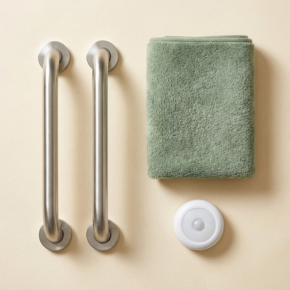 Bathroom Safety Starter Kit: two stainless steel grab bars, sage green bath mat, and motion-sensor night light